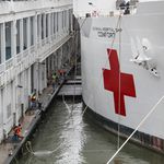 Mooring ropes are released and tossed into the water as the USNS Naval Hospital Ship Comfort is prepared to depart via the Husdon River, in Manhattan